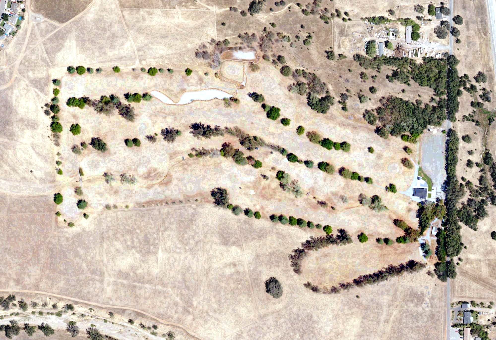 Aerial view of Oak Creek Golf Course (Red Bluff), CA, with its hole routing marked