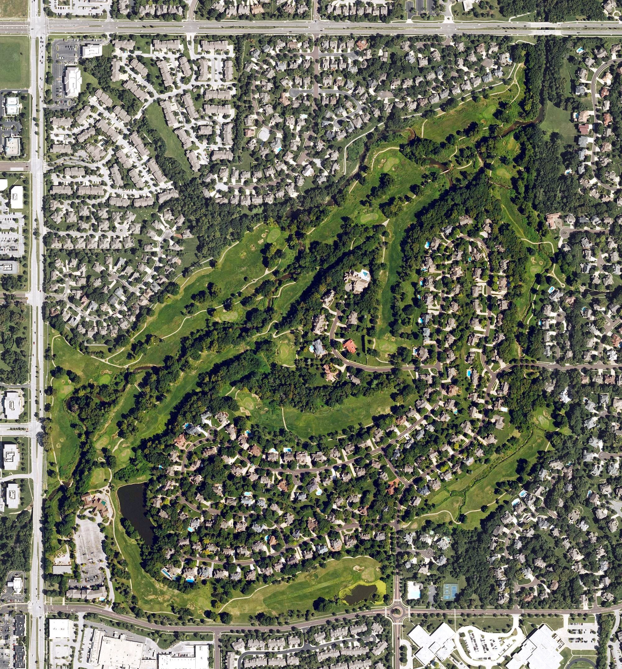 Aerial view of Deer Creek Golf Club, KS, with its hole routing marked