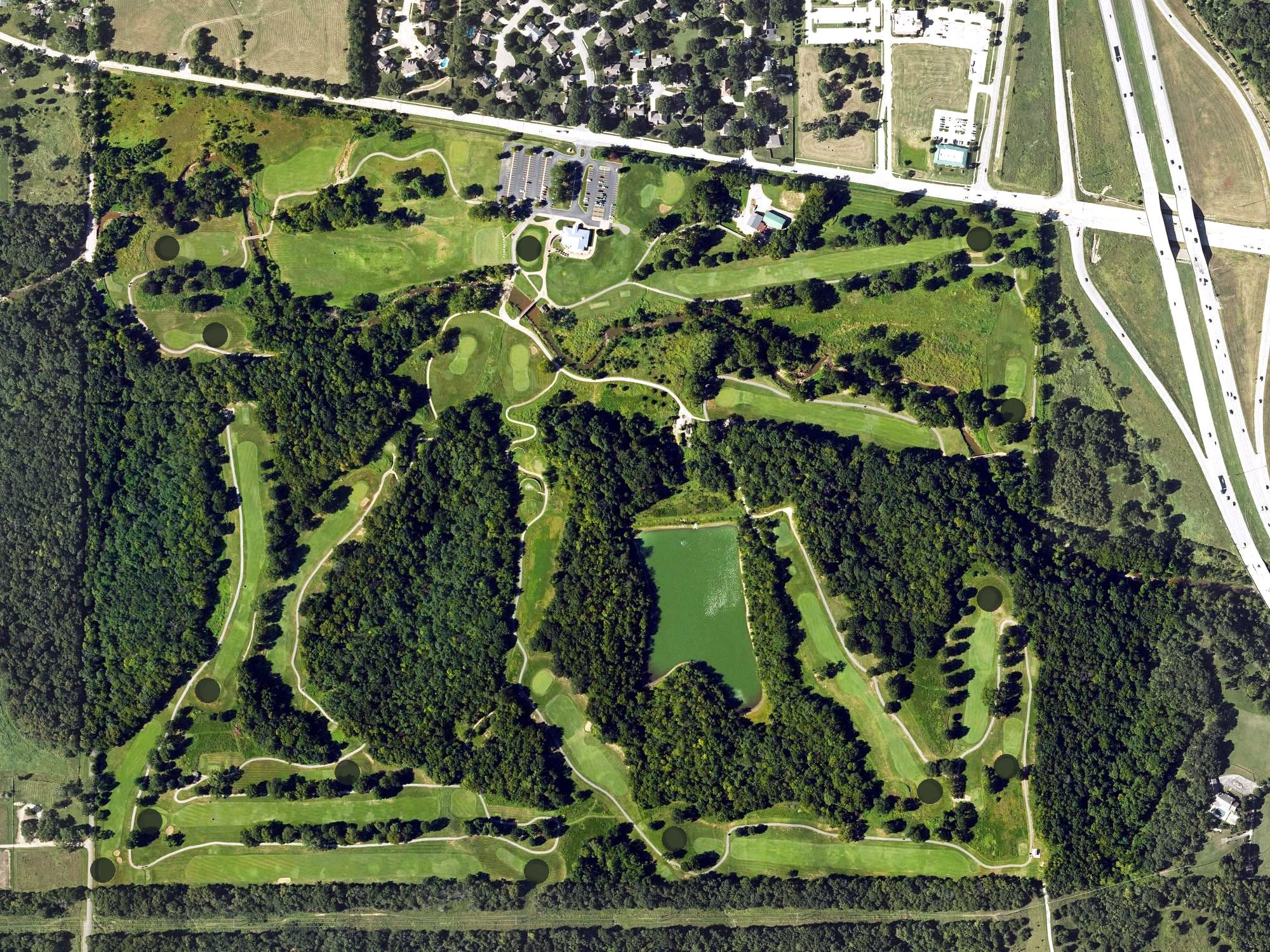 Aerial view of Tomahawk Hills Golf Course, KS, with its hole routing marked