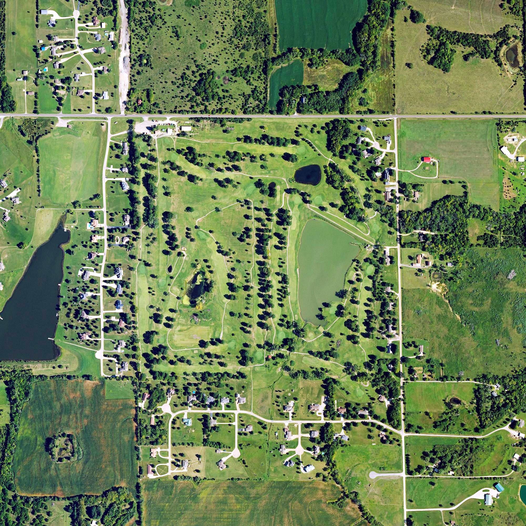 Aerial view of Village Greens Golf Course, KS, with its hole routing marked