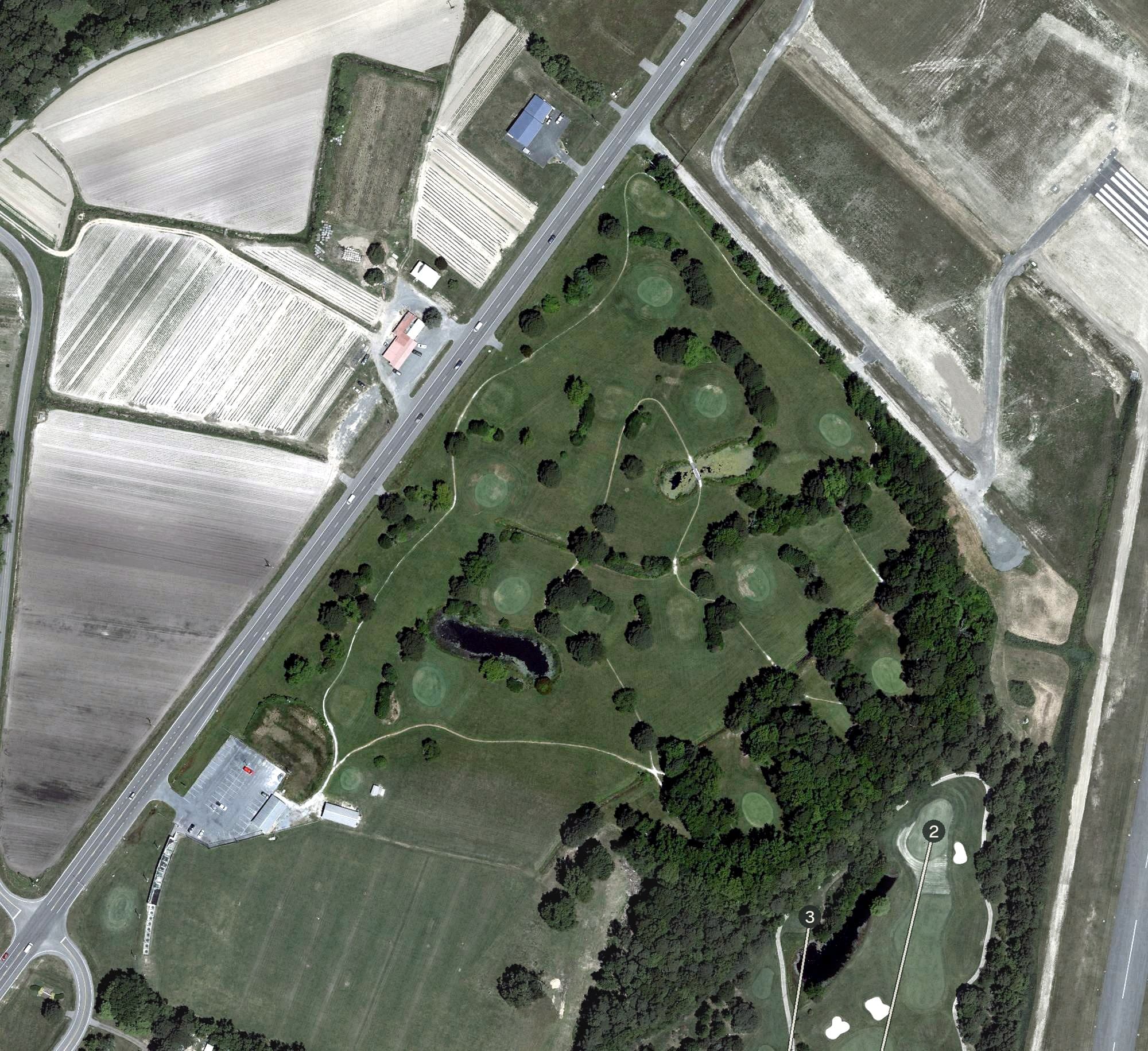 Aerial view of Assateague Greens Golf Course, MD, with its hole routing marked