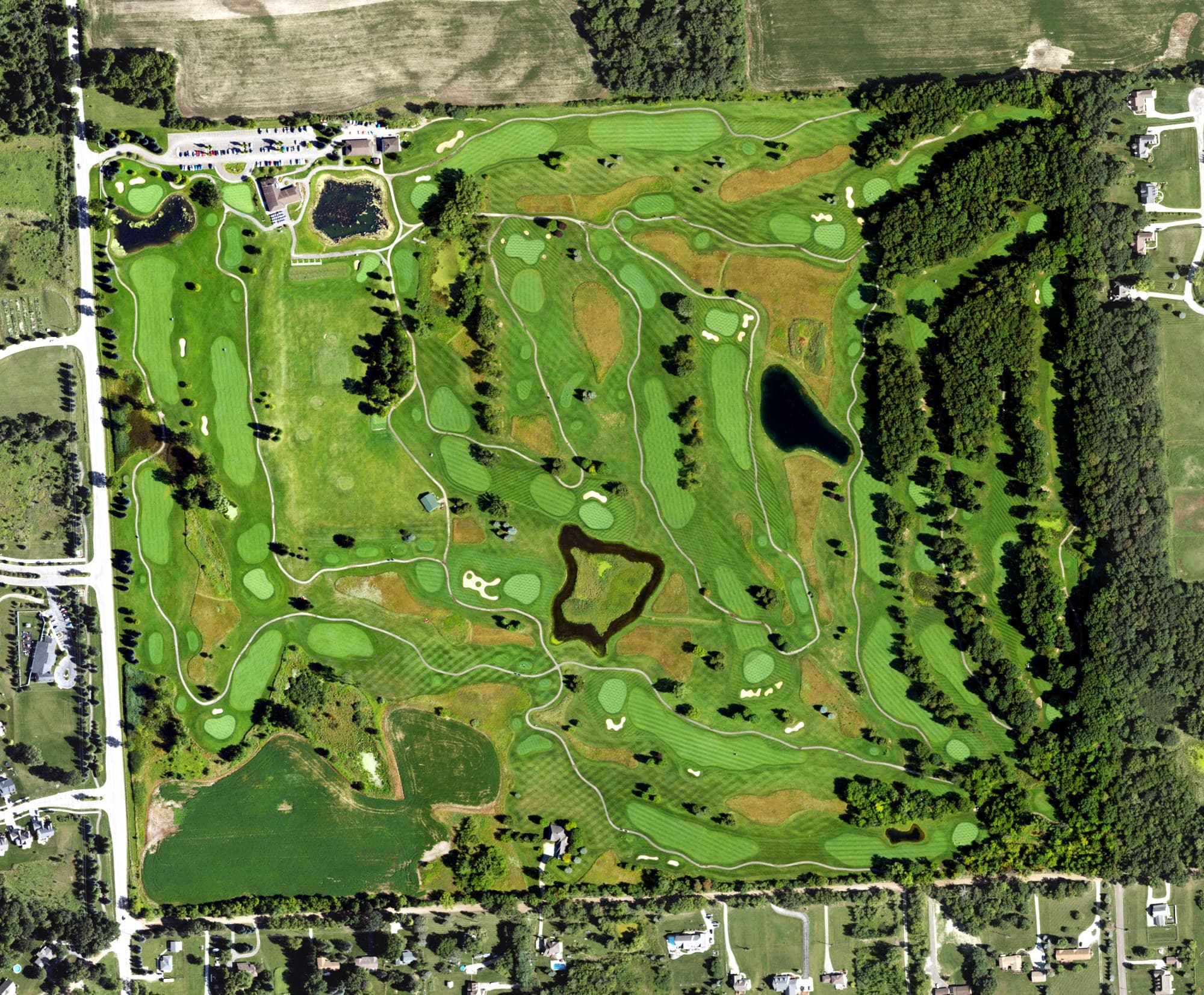 Aerial view of Coyote Golf Club, MI, with its hole routing marked