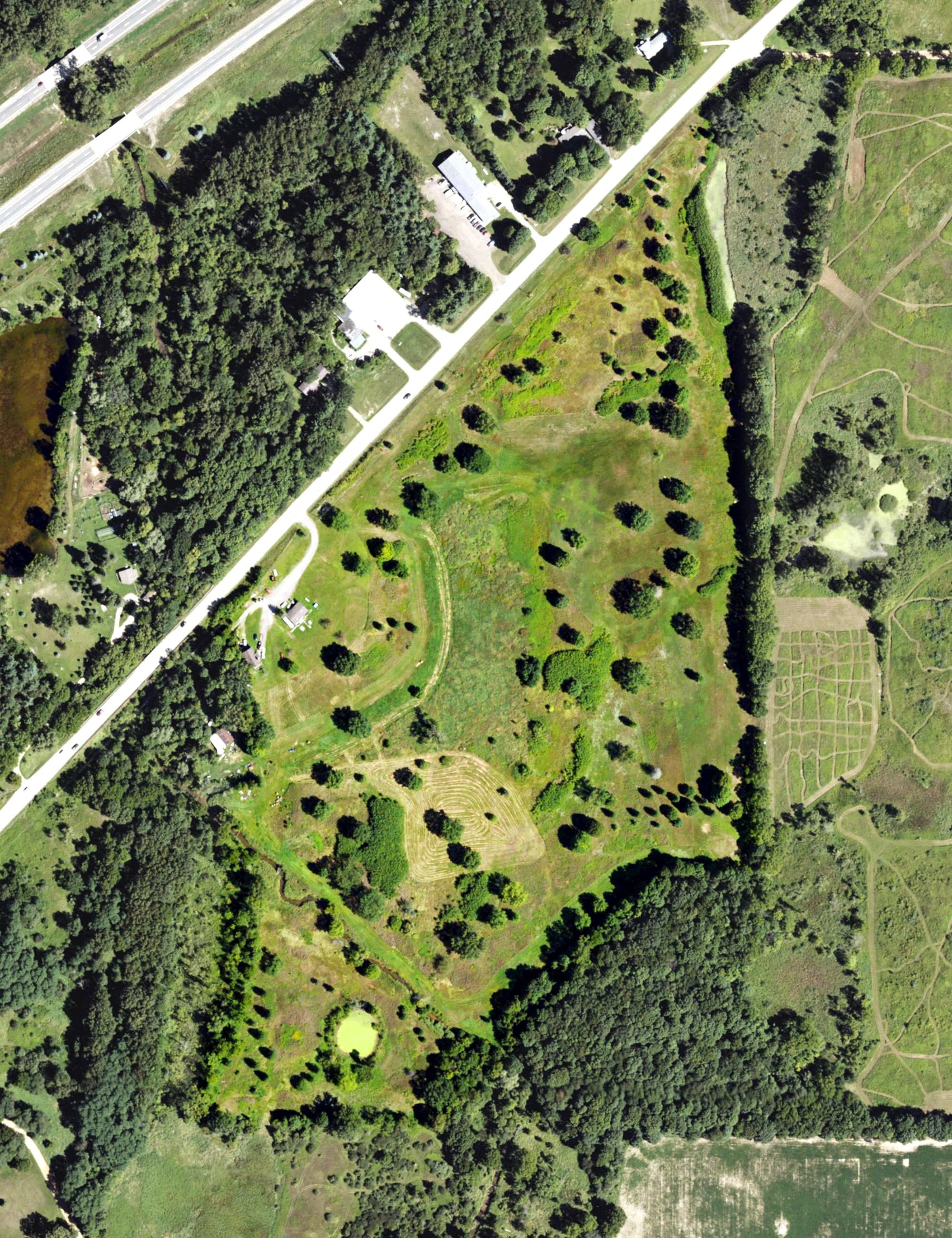 Aerial view of Olivet Country Club, MI, with its hole routing marked