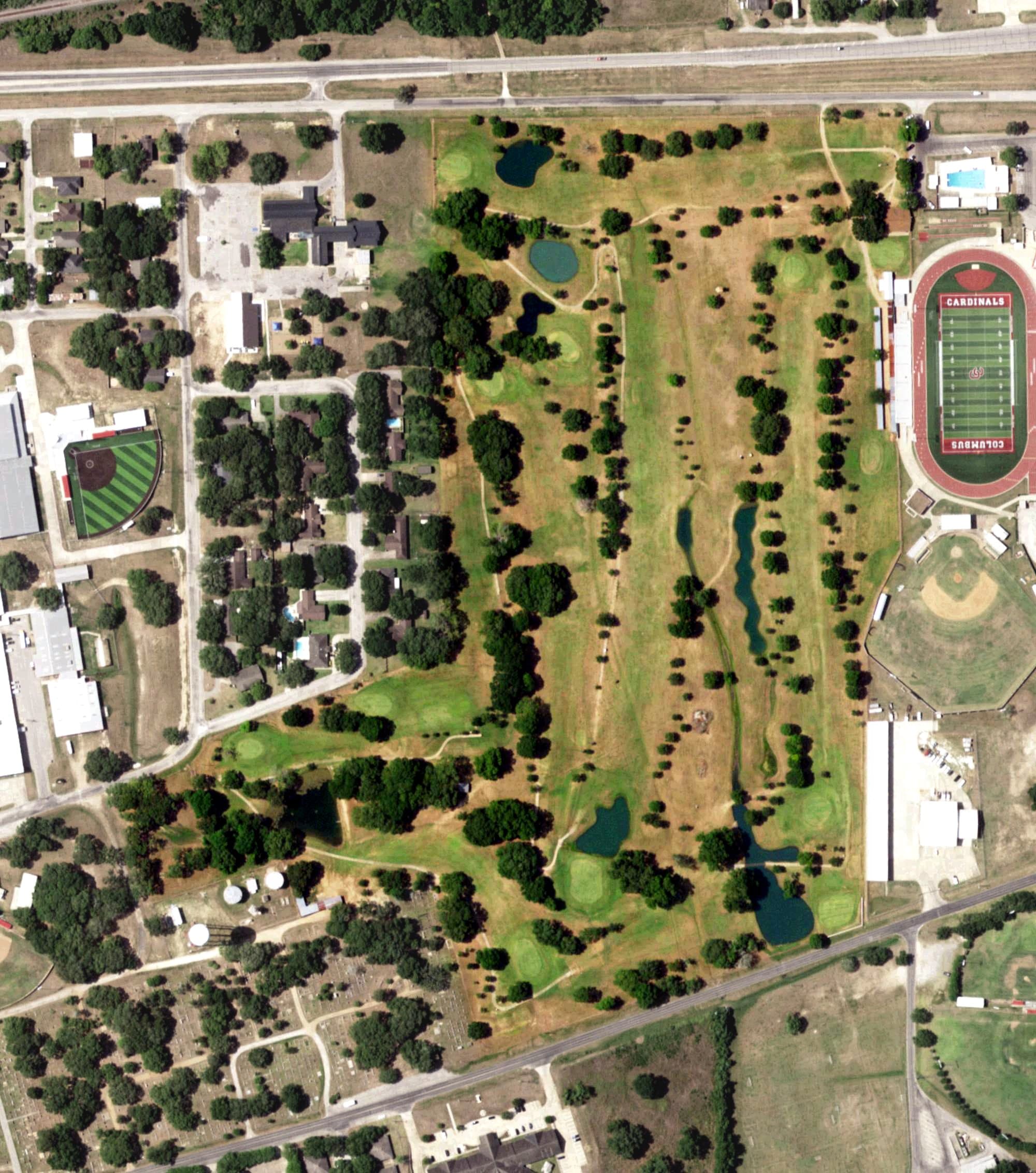 Aerial view of Columbus Municipal Golf Course, TX, with its hole routing marked