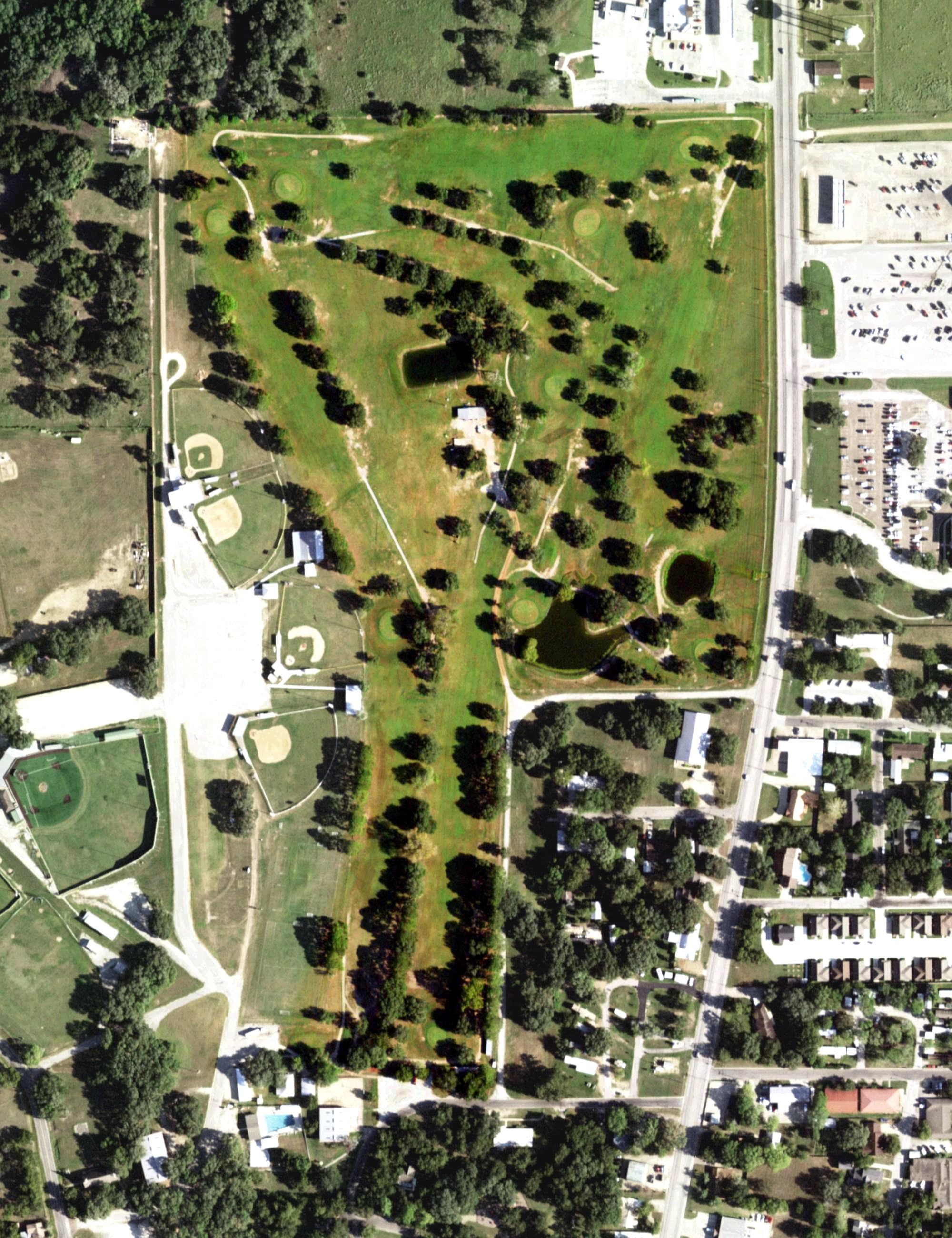 Aerial view of Hallettsville Municipal Golf Course, TX, with its hole routing marked