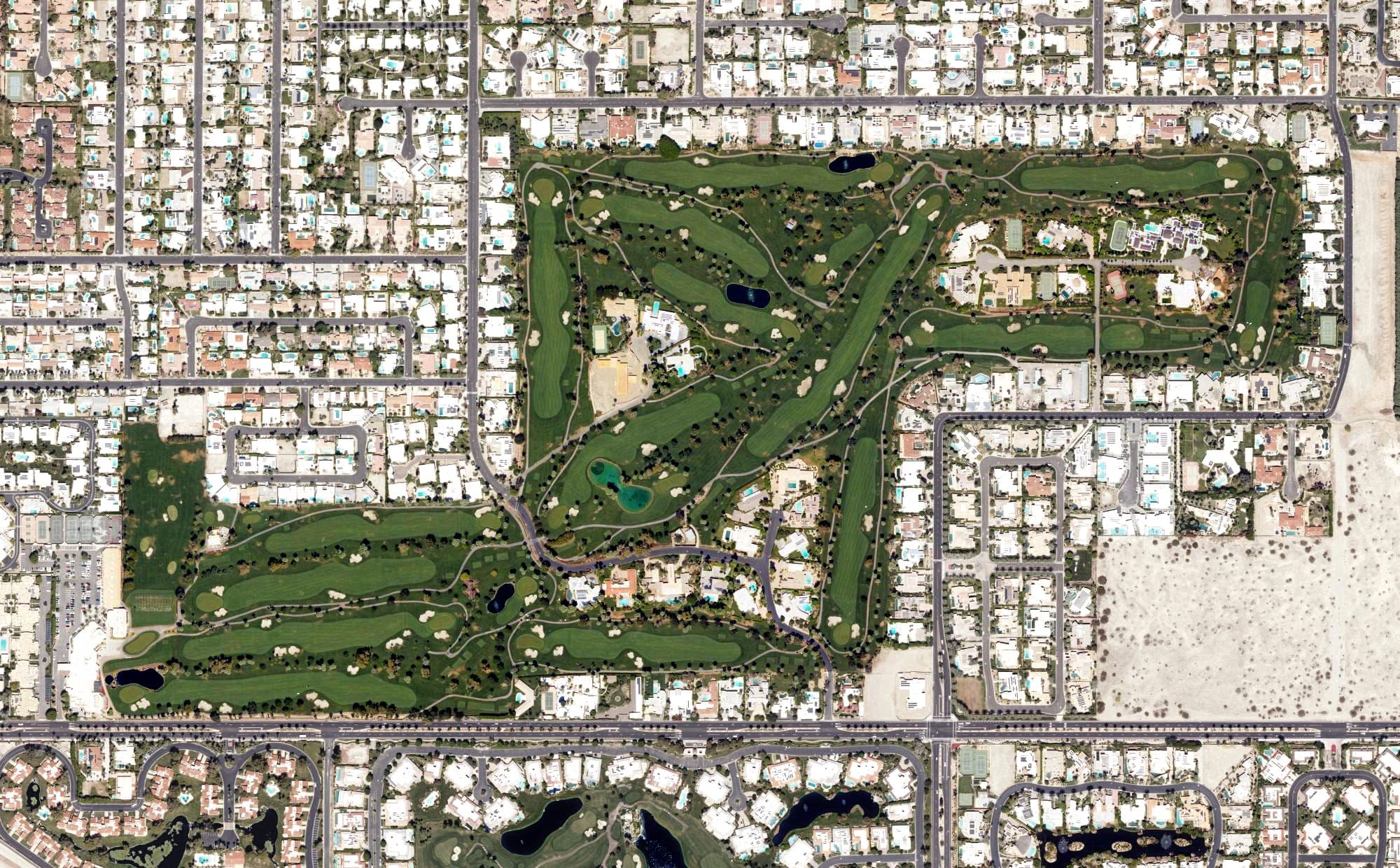 Aerial view of Tamarisk Country Club, CA, with its hole routing marked