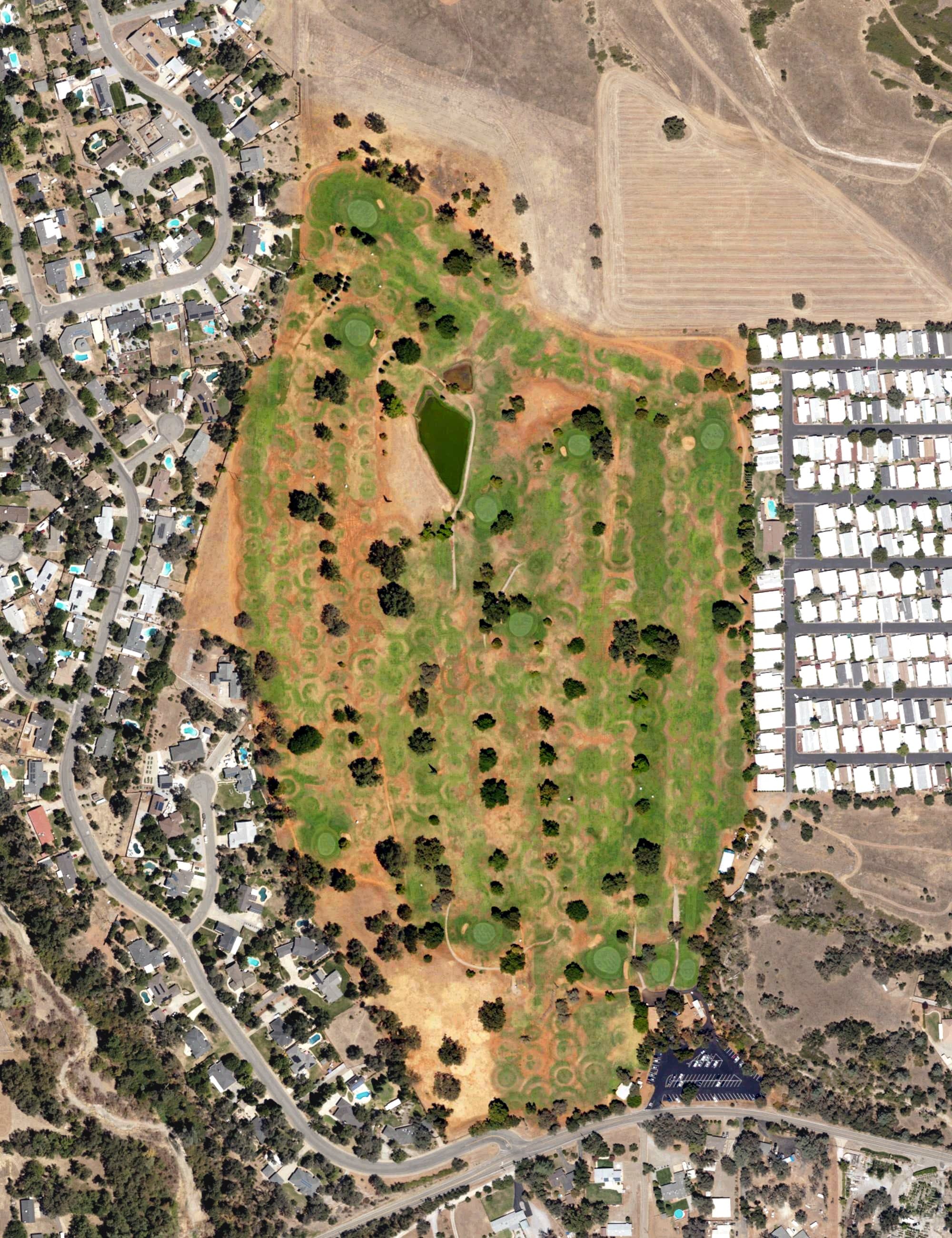 Aerial view of Tucker Oaks Golf Course, CA, with its hole routing marked