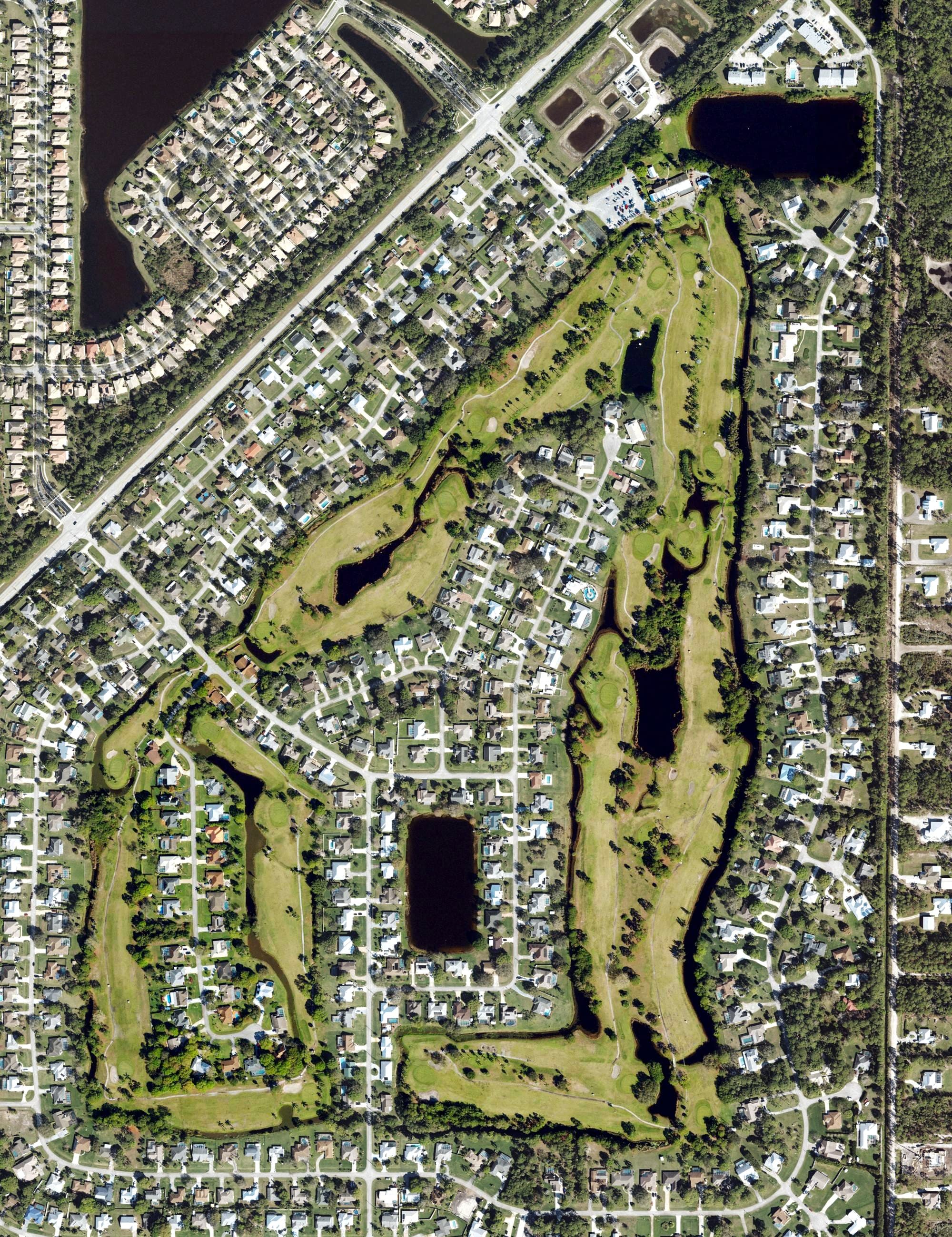 Aerial view of Island Pines Golf Club, FL, with its hole routing marked