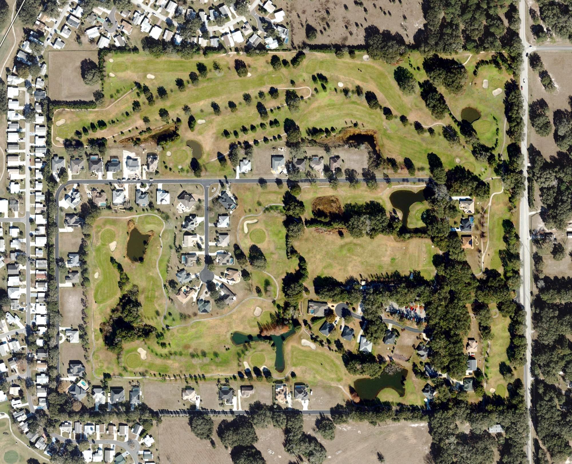 Aerial view of Lakes of Lady Lake Golf Course, FL, with its hole routing marked