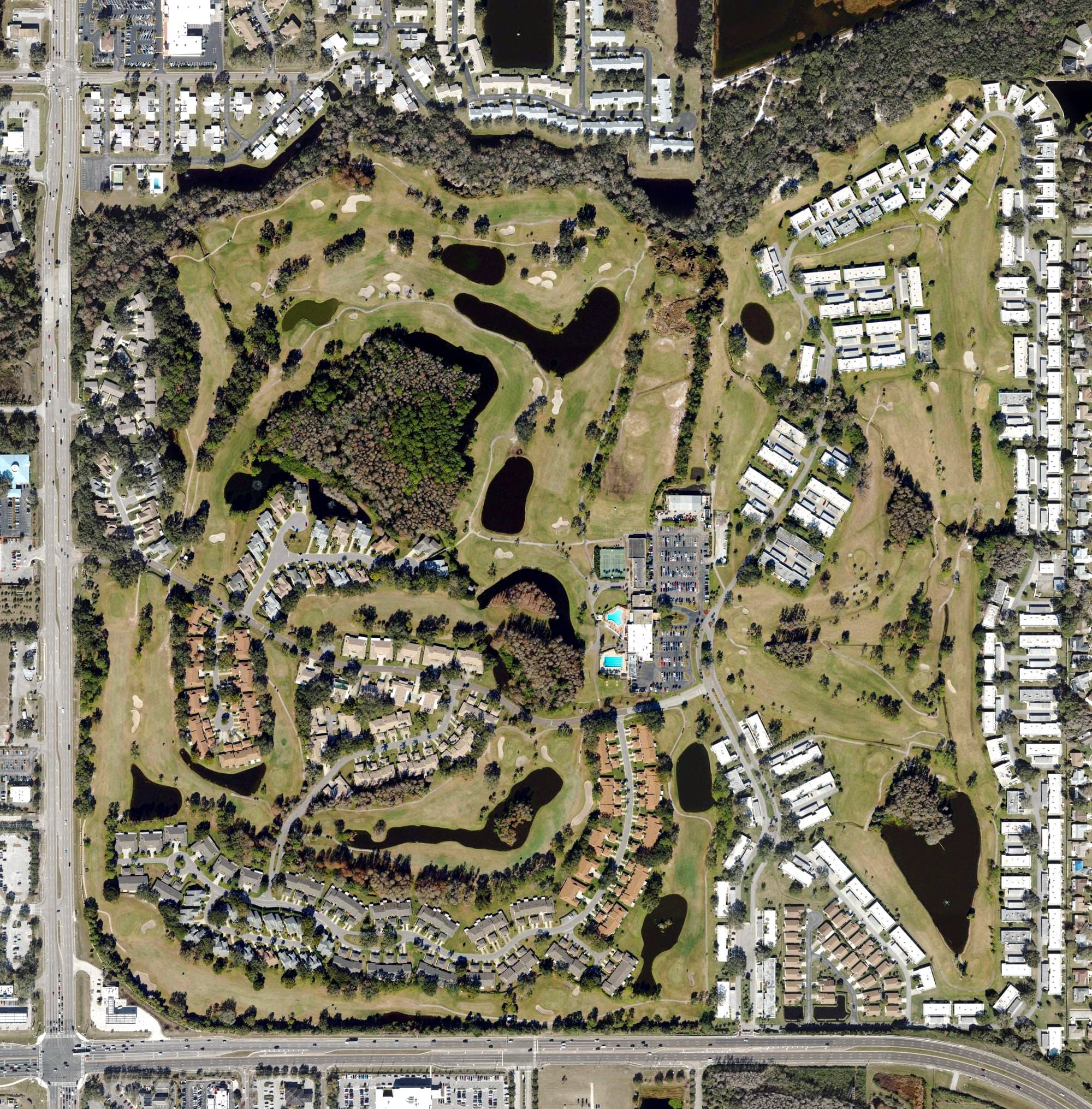 Aerial view of Seven Springs Golf and Country Club Home Page, FL, with its hole routing marked