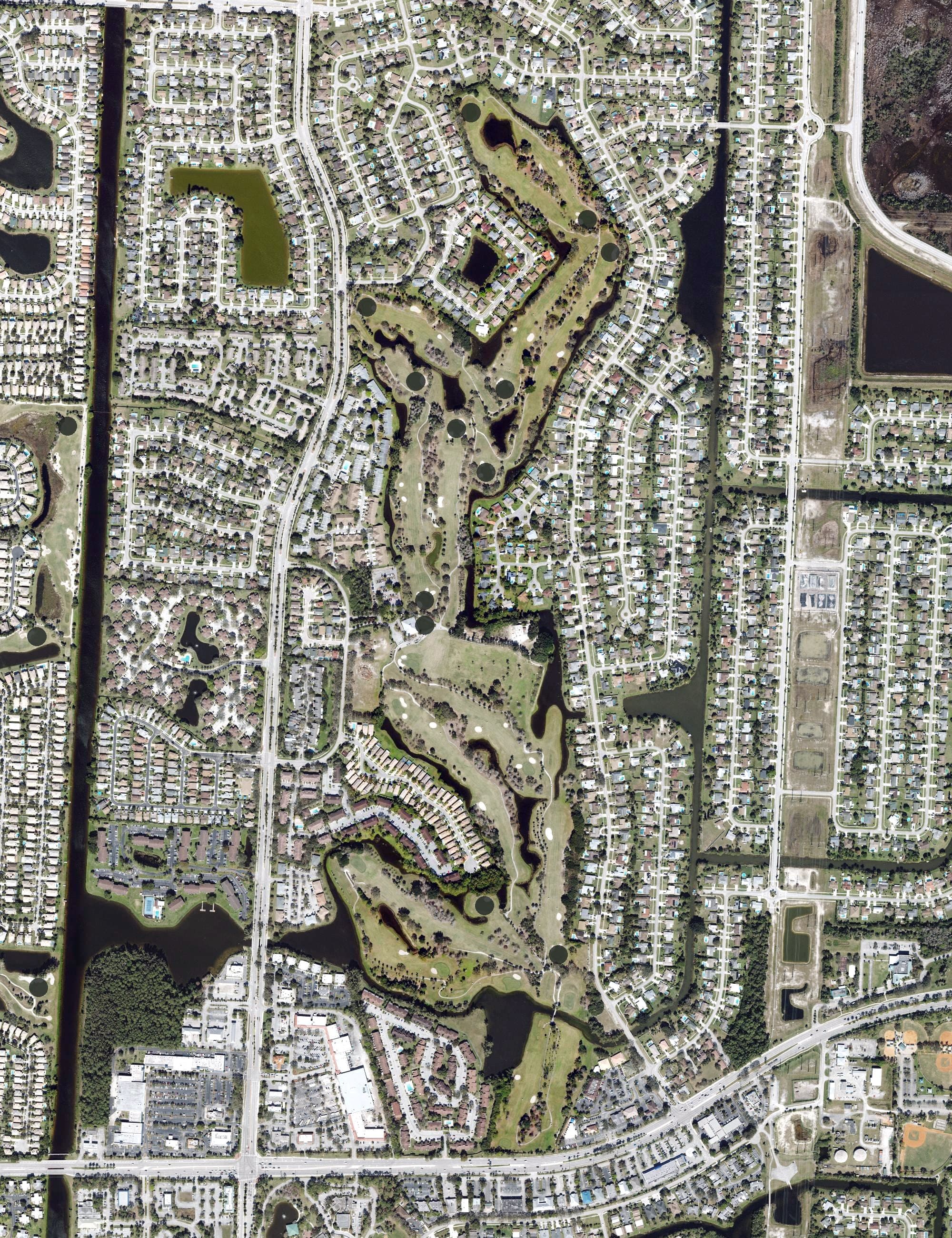 Aerial view of Village Golf Club, FL, with its hole routing marked