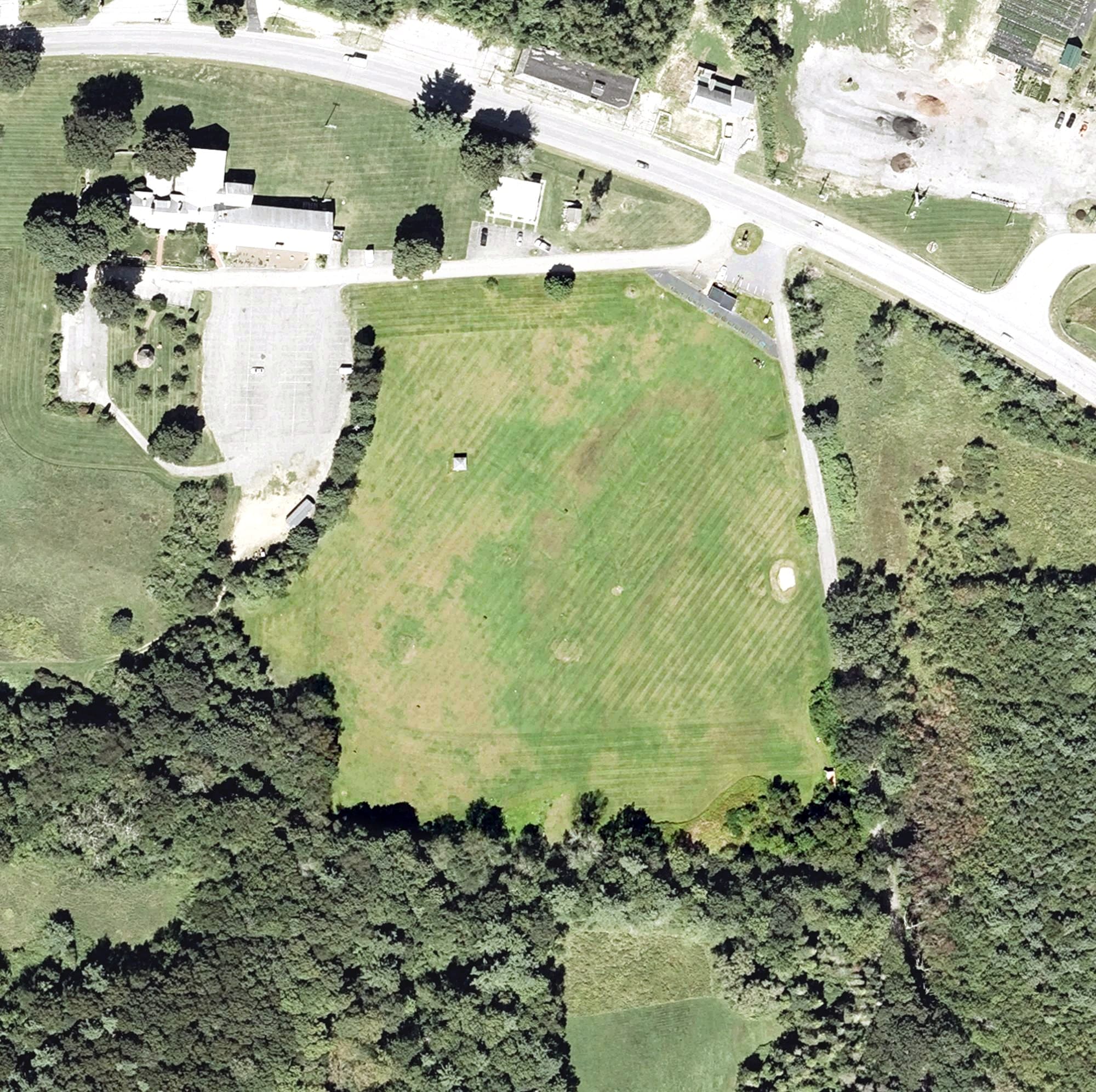 Aerial view of Spencer Driving Range, MA, with its hole routing marked