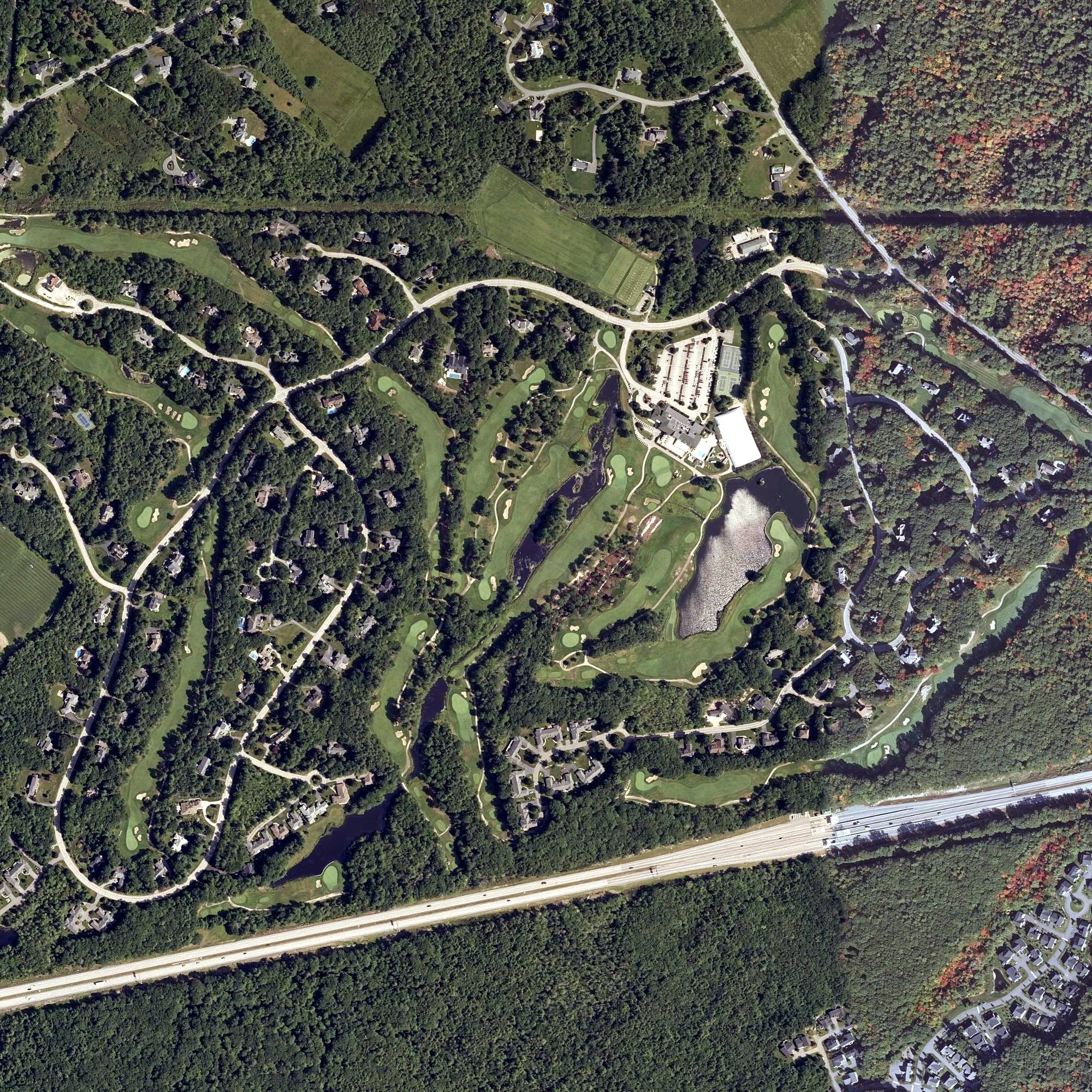 Aerial view of The Woodlands Club, ME, with its hole routing marked