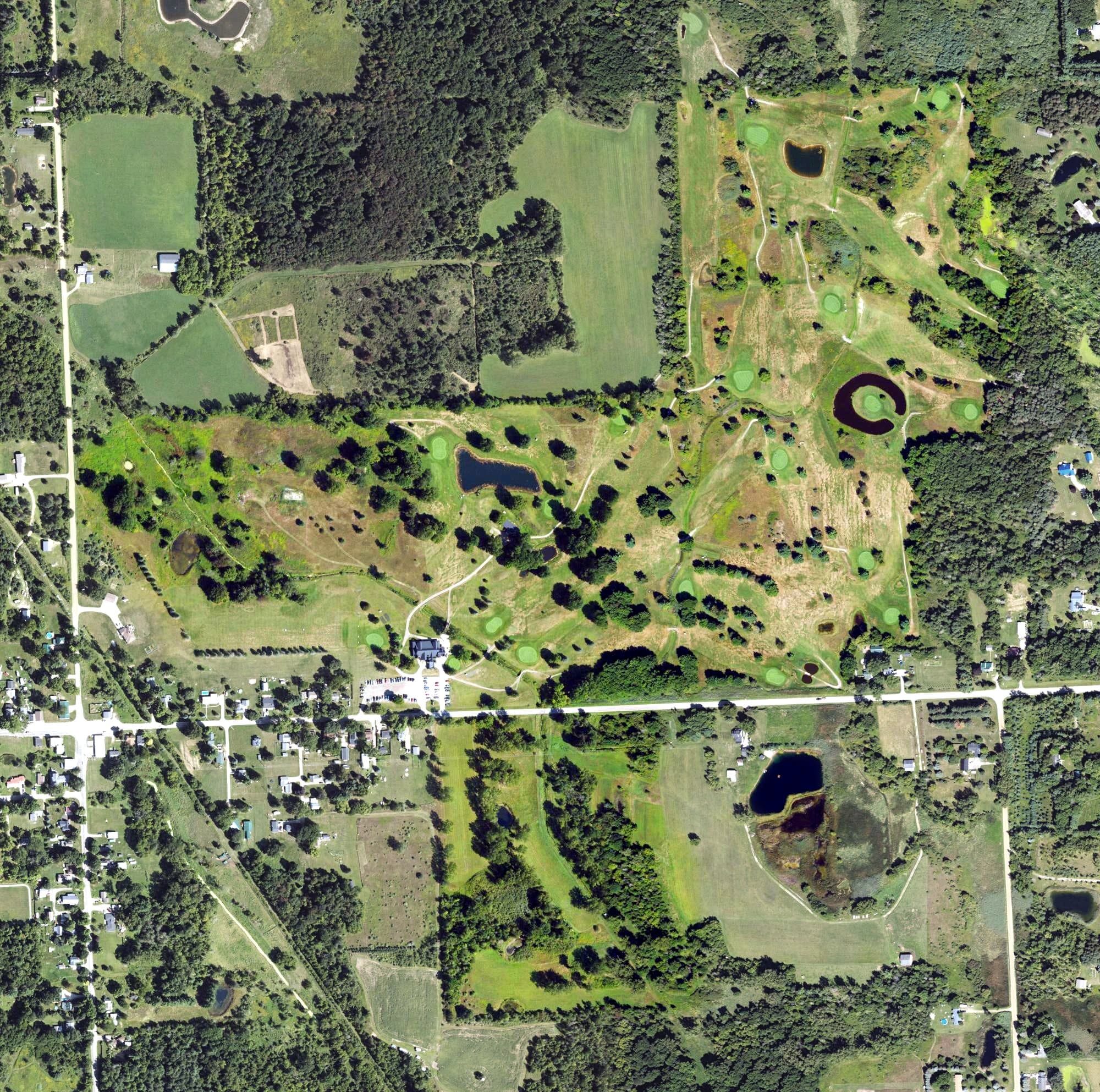 Aerial view of Castle Creek Golf Club, MI, with its hole routing marked