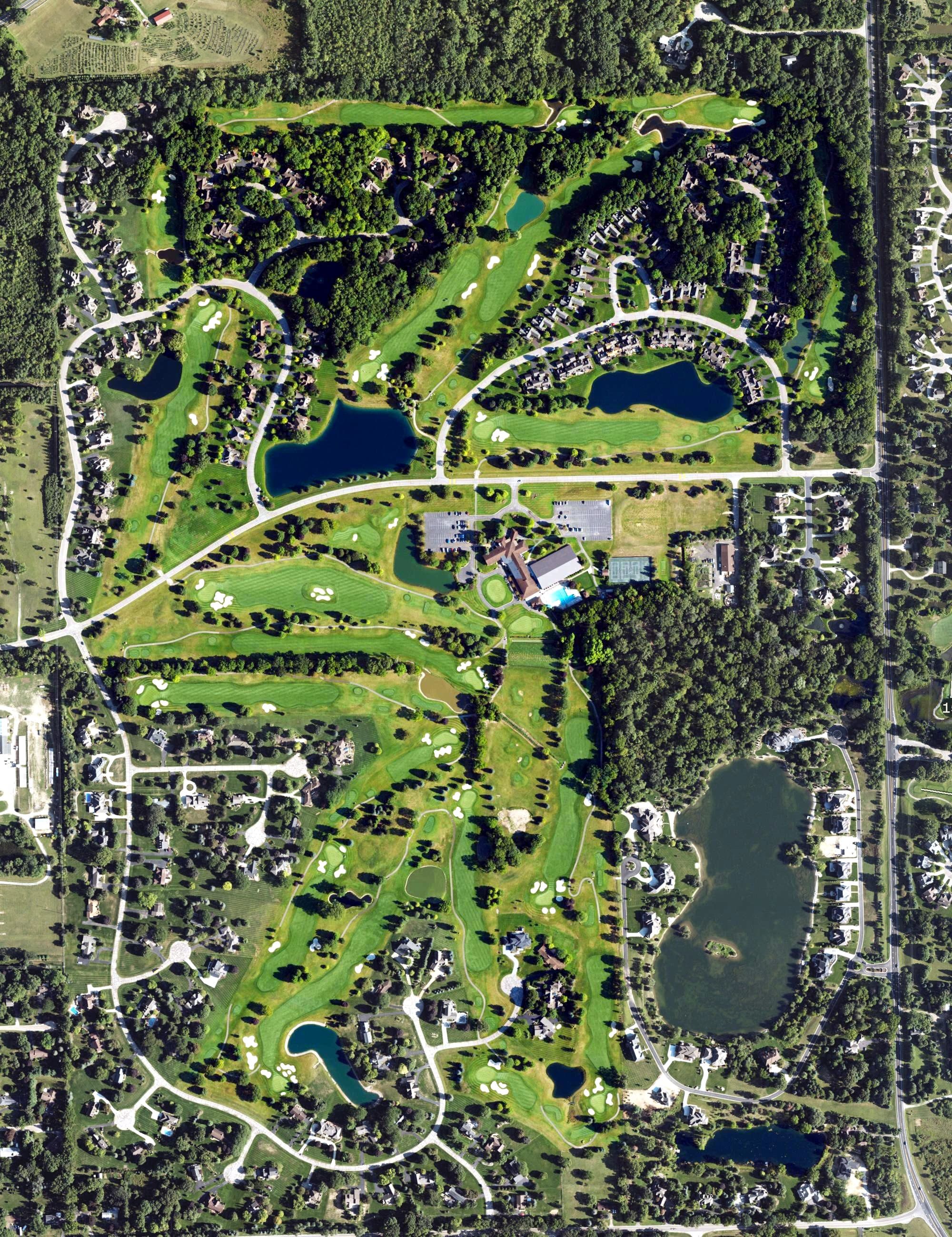 Aerial view of Travis Pointe Country Club, MI, with its hole routing marked