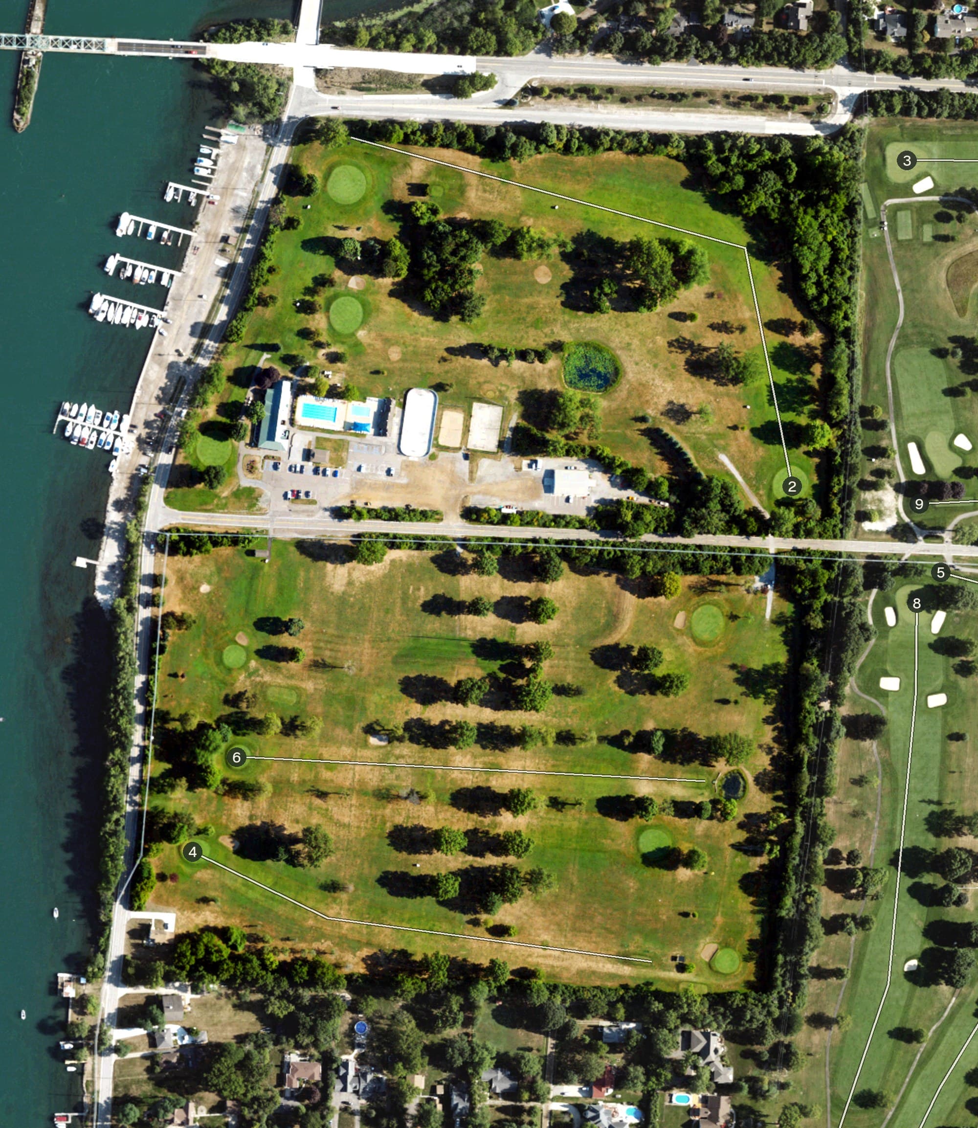 Aerial view of Water's Edge Golf Course, MI, with its hole routing marked