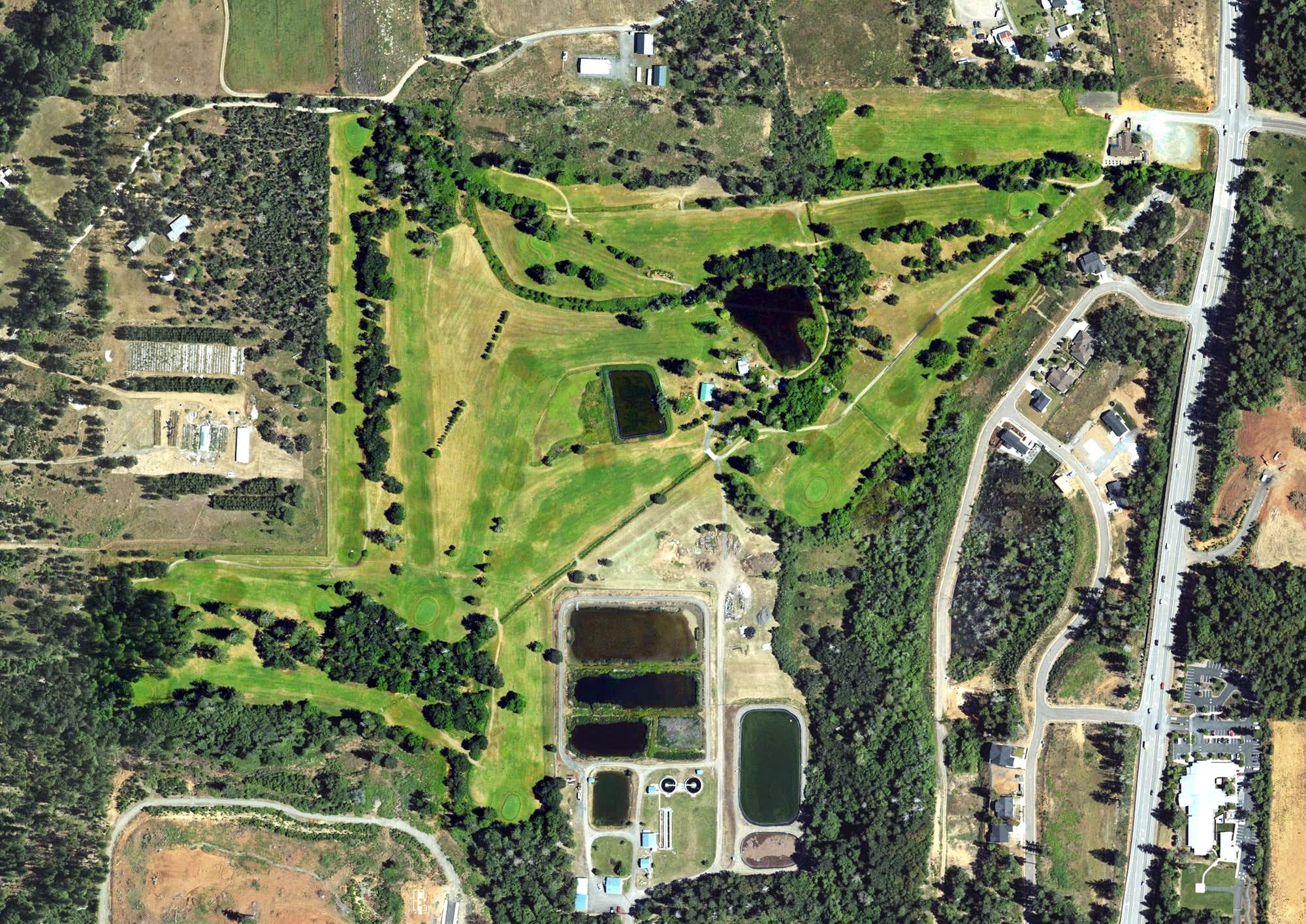 Aerial view of Illinois Valley Golf Club, OR, with its hole routing marked