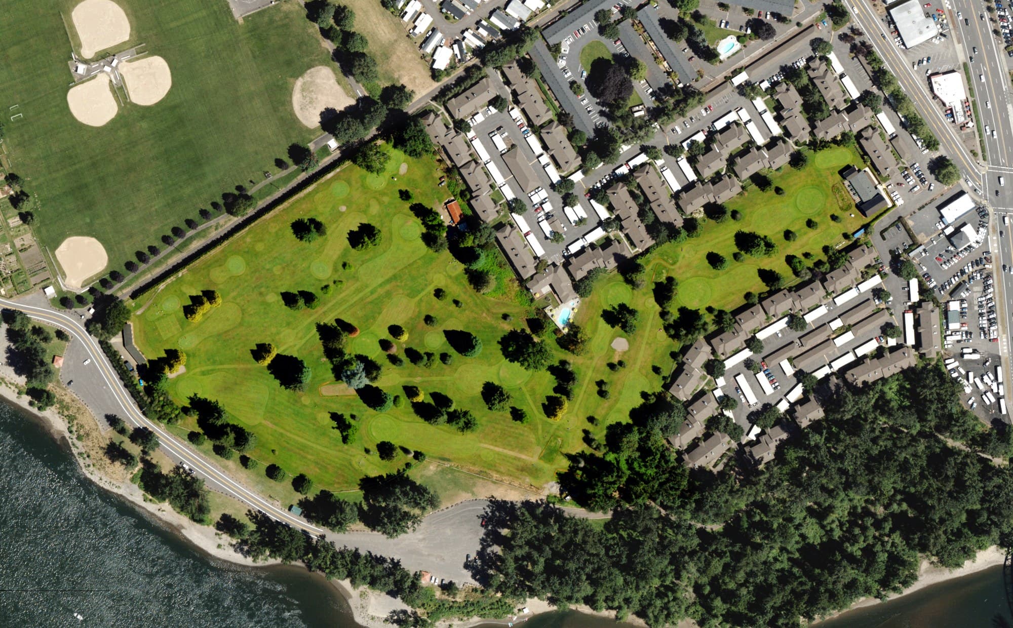 Aerial view of Rivergreens Golf Club, OR, with its hole routing marked